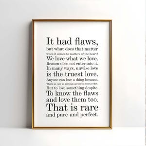 May include: A framed print with a gold-colored frame. The print features black text on a white background. The text includes the phrase "It had flaws" and continues with a poem about love and imperfections.