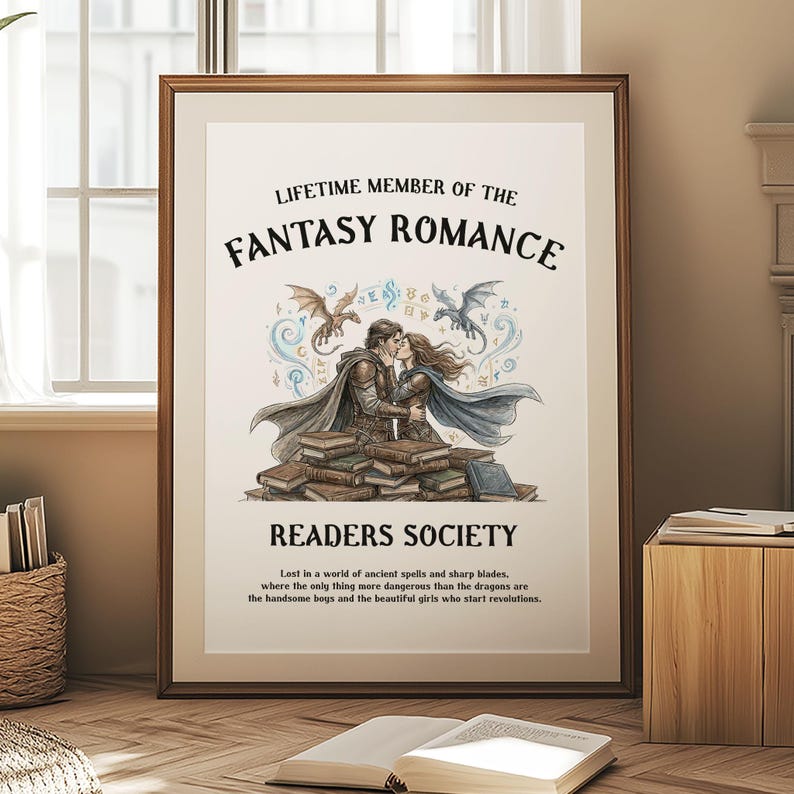 May include: Framed print with the text "LIFETIME MEMBER OF THE FANTASY ROMANCE READERS SOCIETY". The image features a couple kissing, dragons, and a stack of books. The print is in a wooden frame.