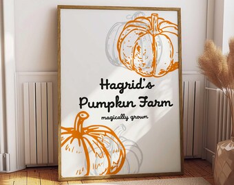 May include: A framed print featuring orange pumpkin illustrations and the text "Hagrid's Pumpkin Farm, magically grown." The artwork has a white background and a wooden frame, perfect for fall decor.