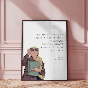 May include: A framed art print with a cartoon illustration of Luna Lovegood. The print features the quote: "Being different isn't a bad thing, it means you're brave enough to be yourself." The print is in a dark brown frame.
