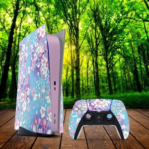 May include: A pink and blue PlayStation 5 console with a floral design and a matching controller. The console and controller feature a light blue background with pink and white flowers.