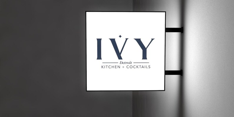 May include: A white sign with black text that reads "IVY Detroit KITCHEN + COCKTAILS".