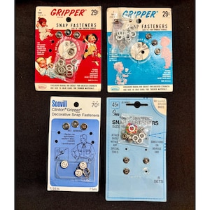 May include: Four vintage packages of metal snap fasteners. The top left is a red Gripper card, top right is a blue Gripper card, bottom left is a blue Scovill Clinton Gripper card, and bottom right is a light blue Sears Dot Snapper card with eight sets.