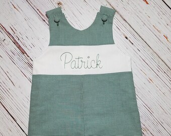 May include: Green and white gingham baby overalls with a white band across the chest that says "Patrick" in green embroidery.