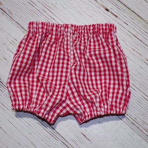 May include: Red and white gingham baby bloomers with elastic waistband.