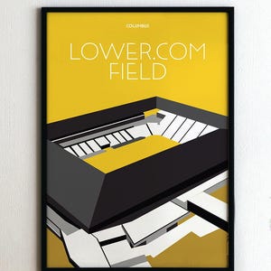 May include: Framed art print featuring a geometric illustration of Lower.com Field in Columbus, Ohio. The artwork uses a palette of yellow, black, gray, and white. The text "COLUMBUS" and "LOWER.COM FIELD" are displayed in white.