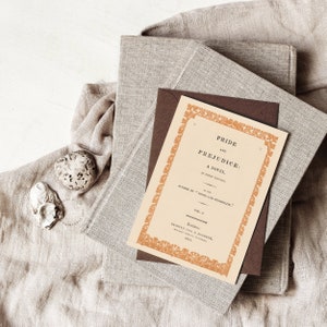 Downloadable Art of the Pride & Prejudice book cover printed on a greeting card, on top of a pile of books. | DearAliceArt.com