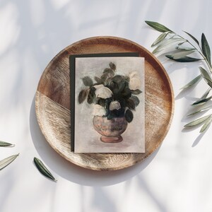 Vintage European Painting of White Peonies Bouquet in a pot, reproduced on a greeting card with a dark green envelope, placed on a rond wooden plate with with olive branches on each side. | Dear Alice Printable Art