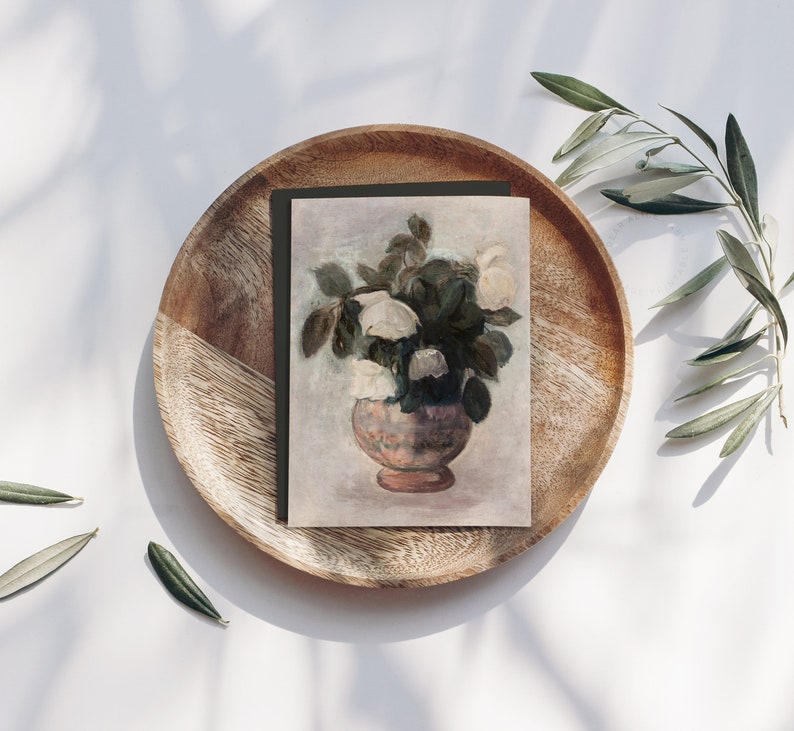 Vintage European Painting of White Peonies Bouquet in a pot, reproduced on a greeting card with a dark green envelope, placed on a rond wooden plate with with olive branches on each side. | Dear Alice Printable Art