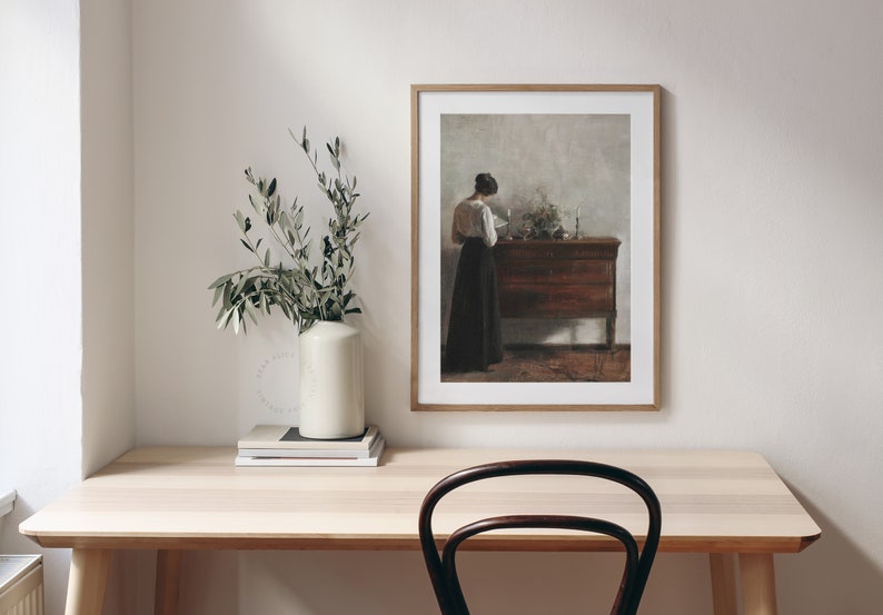 Vintage Antique Painting of a woman reading next to an antique sideboard. Printable Art hung on the wall of a modern home office decor. | Dear Alice Art