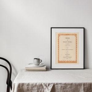 Pride & Prejudice Book Cover Art Print enlarged, framed and displayed on the table of a farmhouse dinning room decor. | Dear Alice Printable Wall Art