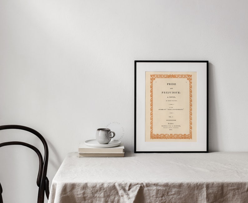 Pride & Prejudice Book Cover Art Print enlarged, framed and displayed on the table of a farmhouse dinning room decor. | Dear Alice Printable Wall Art