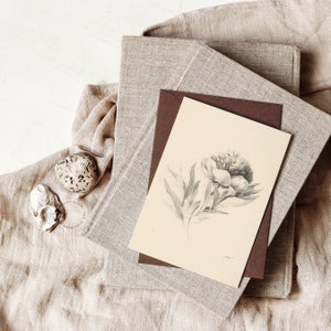 Printable Flower Art used on a Greeting Card with a dark brown enveloppe, on top of a pile of books with linen covers | Dear Alice Art