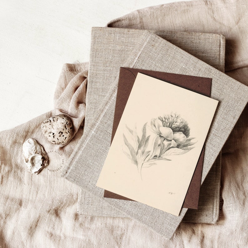 Printable Flower Art used on a Greeting Card with a dark brown enveloppe, on top of a pile of books with linen covers | Dear Alice Art