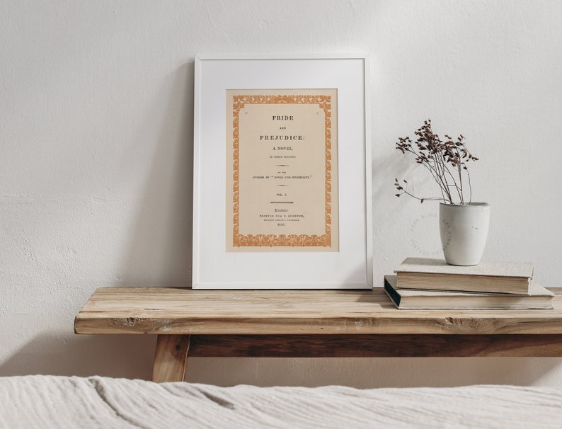 Printable reproduction of a antique book cover enlarged framed in a warm and muted bedroom decor with antique furniture. | Dear Alice Art