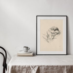 Downloadable Art of a beautiful flower drawing on a cream paper, framed and displayed on a table with a linen tablecloth, a chair and a cup of coffee | Dear Alice Vintage Art