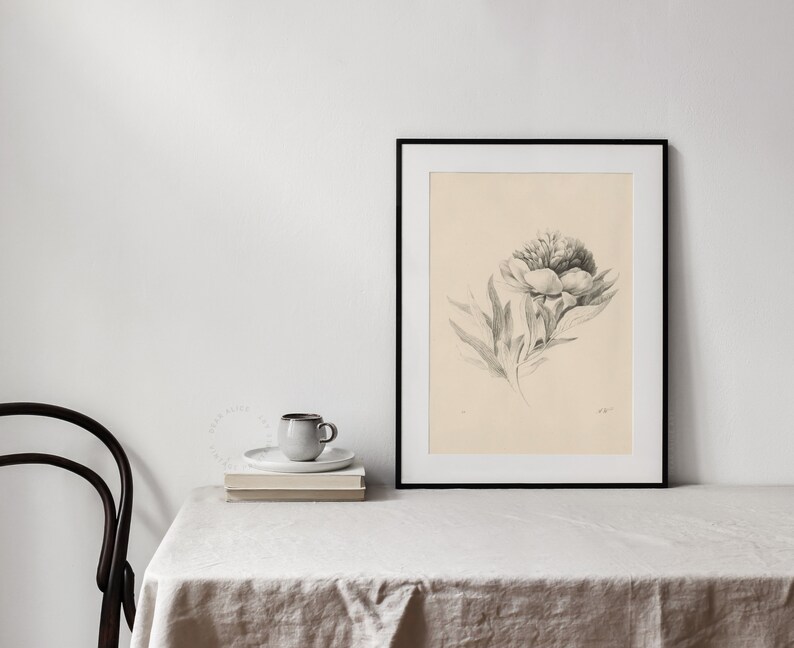 Downloadable Art of a beautiful flower drawing on a cream paper, framed and displayed on a table with a linen tablecloth, a chair and a cup of coffee | Dear Alice Vintage Art