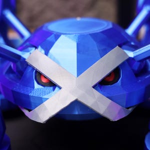 May include: A blue and silver 3D printed model of a Pokemon character with red eyes. The model is designed to look like a creature with a hard exoskeleton.