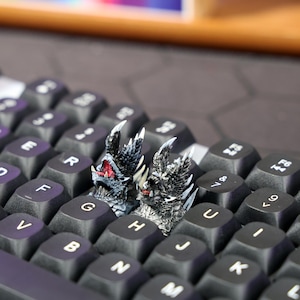 Custom keycap for mechanical keyboards, inspired by Monster Hunter powerful dragons, with a hand-painted finish and easy compatibility with MX-style switches, ideal for personalizing gaming setups.
