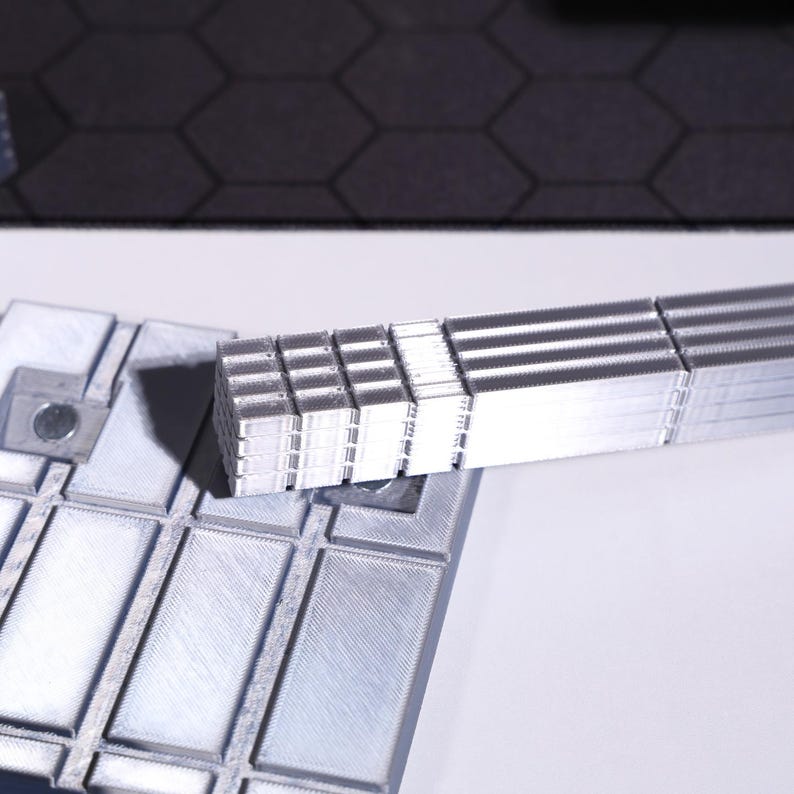Interstellar sci-fi TARS robot figure, high-detail collectible model; metallic finishes in stainless steel and gunmetal; adjustable modular joints, pop culture display decor for fans and collectors, ideal futuristic display piece for movie lovers.