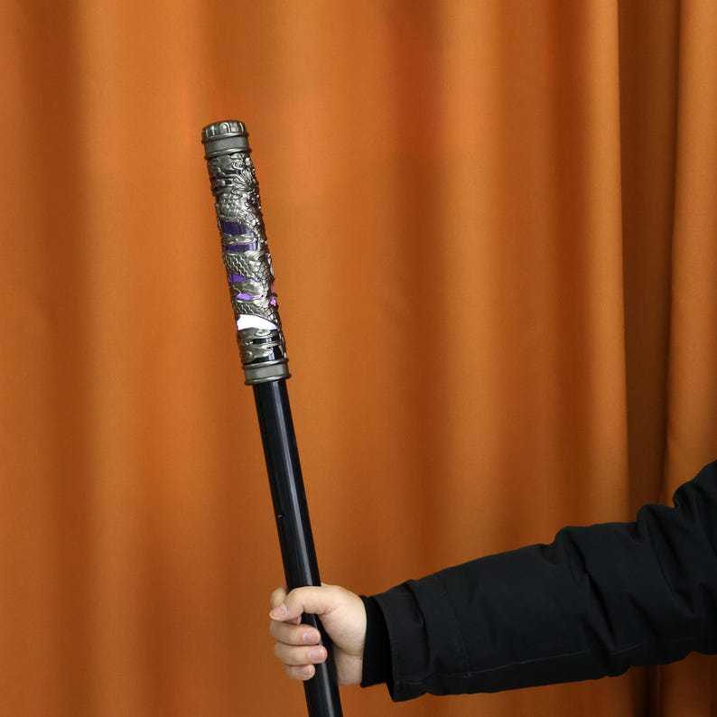 Dynamic Monkey King staff with seven-color LED lighting, air-control retract feature, and rechargeable battery. Perfect for gaming, cosplay props, or as a unique gift for fantasy fans and performance enthusiasts.