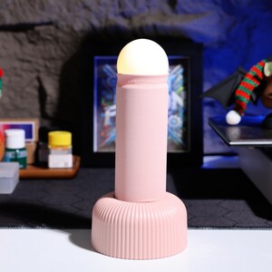LED night light for a calming, flicker-free glow, perfect for game rooms or as a unique addition to bedroom decor. Rechargeable, long-lasting, and stylish with a soft-touch finish for comfort and aesthetics.