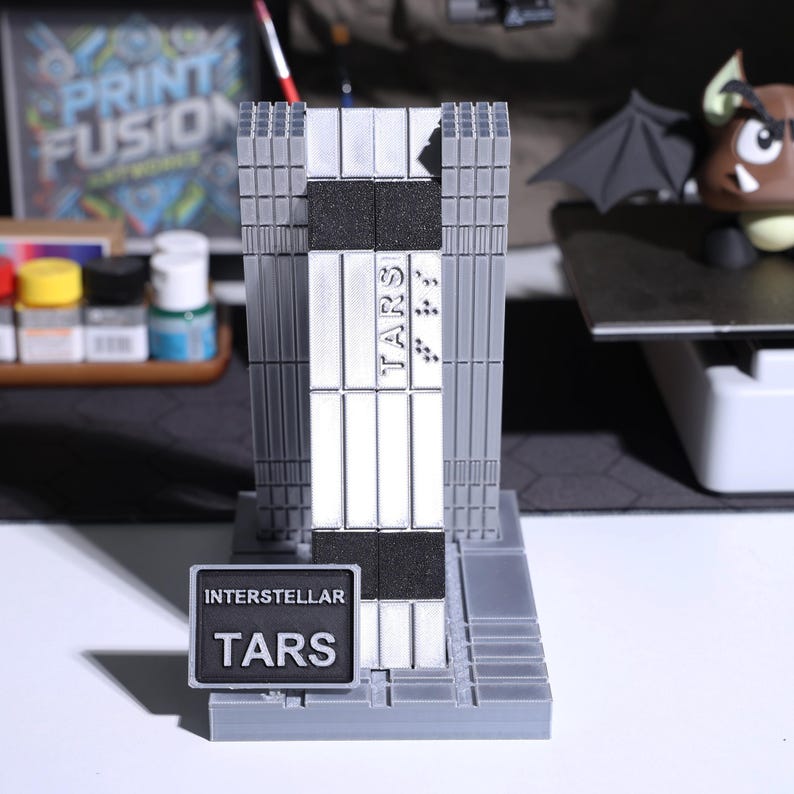 Collectible TARS robot figure from Interstellar; sci-fi robot display with modular magnetic joints, metal-look finishes; movie-inspired replica, popular for fan collections and modern decor, durable and lightweight collectible shelf or desk model.