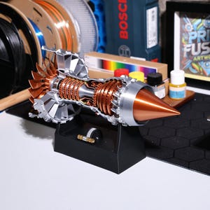 Detailed 3D printed turbofan engine replica with rotating fan blades; ideal aviation-themed gift; sustainable PLA material, easy setup; functional model aircraft engine, collectible desktop decor; aviation ornament, realistic aircraft engine display.