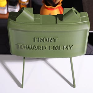 Claymore Bluetooth speaker, military decor, rugged desk speaker, audio gift for veterans, realistic military-inspired speaker, claymore mine design, personalized Bluetooth sound, military-, home office speaker, unique gift for military collectors