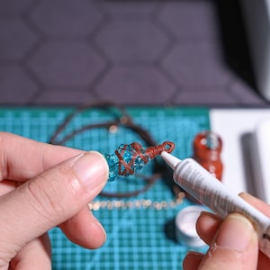 Handmade gaming pendant DIY kit featuring FF14-inspired designs, resin charm, beads, and metal pendant – create your own custom necklace or keychain. Perfect gift for gamers and Final Fantasy XIV enthusiasts.