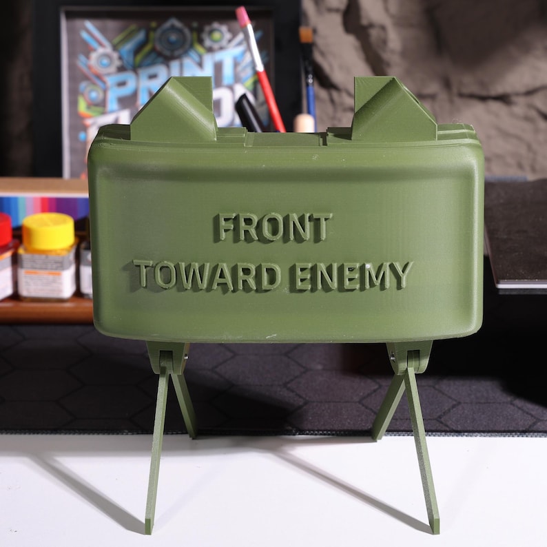 Claymore design Bluetooth speaker, military-inspired decor, realistic claymore mine, high-quality 3D printed speaker, rugged decor piece, veteran gift, personalized Bluetooth sound, unique claymore decor, collectible speaker, militarythemed Bluetooth