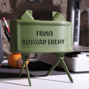 Personalized military Bluetooth speaker, claymore mine-inspired design, unique gift for military fans, realistic claymore audio device, Bluetooth speaker decor, high-quality sound, collectible audio decor, military-inspired gift, unique speaker desig