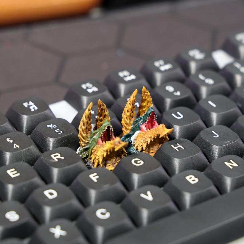 Unique gaming keycap for mechanical keyboards, featuring intricate dragon-themed design, perfect for customizing your gaming setup or enhancing your keyboard aesthetics with a custom touch.