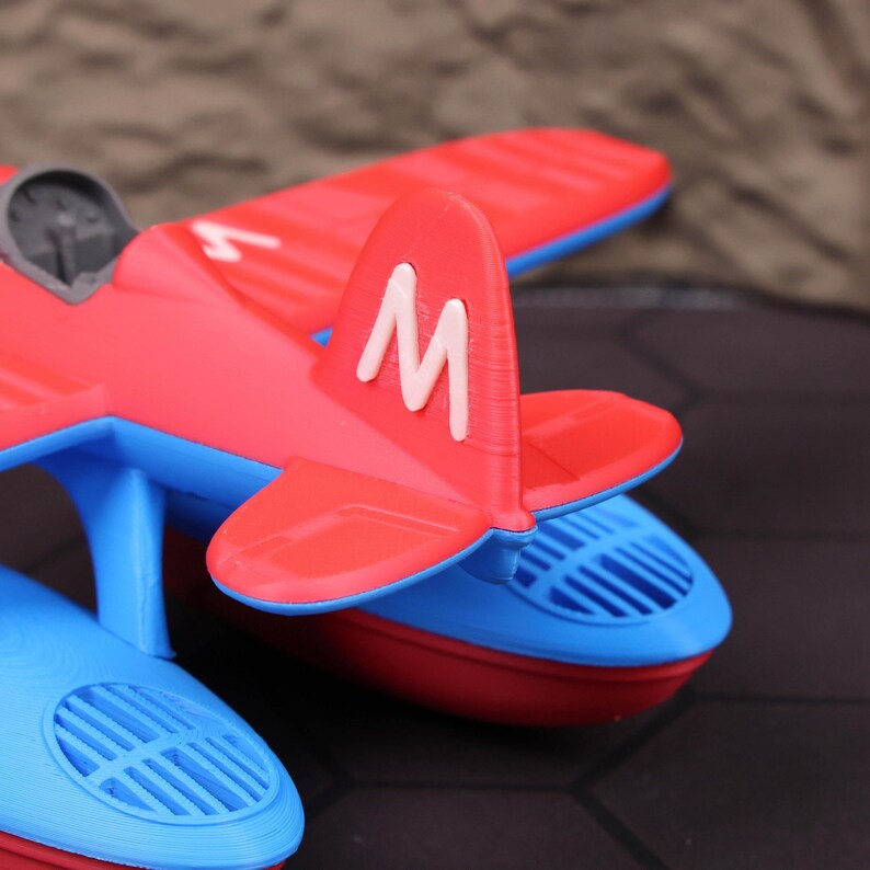 Unique aviation seaplane model showcased as shelf decor with festive Christmas and Halloween elements, making it a multifunctional gift for holidays. This 3D printed floatplane is not just a toy but also a conversation starter and decor piece for pilots and aviation enthusiasts. Ideal for bathtime fun, water play education, or home office decoration. Designed for both kids and collectors, it fits perfectly into holiday gift guides and STEM toy categories
