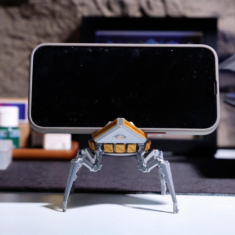 Phone holder with rotating head, Apex-themed phone stand for desktop use, great as a gift for Apex Legends gamers, eco-friendly and sustainable material, ideal for keeping your phone visible during gaming sessions.