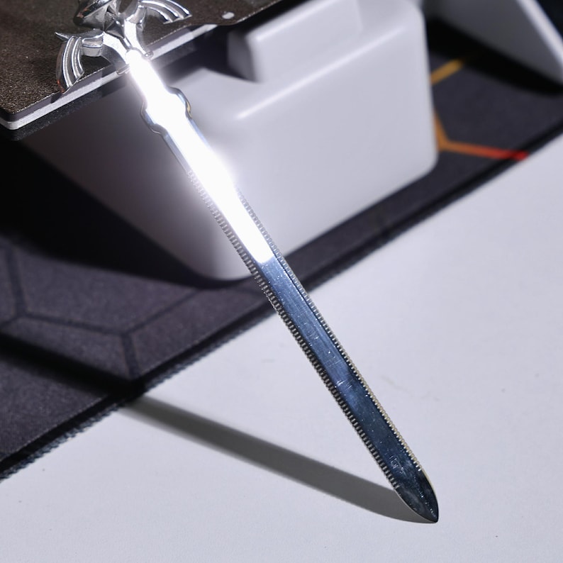 May include: A silver sword with a pointed tip and a textured blade.