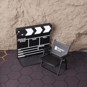 Close-up view of the 3D printed miniature director’s chair and clapperboard, highlighting the precision of the print and texture of the materials. Designed to mimic the look of real film set equipment, this collectible is perfect for creative desk decor, film student gifts, or indie filmmakers looking to add a unique touch to their studio. This photo showcases the fine details and realistic proportions that make this miniature kit a conversation starter in any setting.