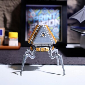 Handcrafted Apex Pack Loot Box Phone Stand - 3D printed, eco-friendly PLA material, perfect for Apex Legends gamers, functional phone stand, gaming gift, video call holder, desktop gaming decor, and unique collectible for game enthusiasts.
