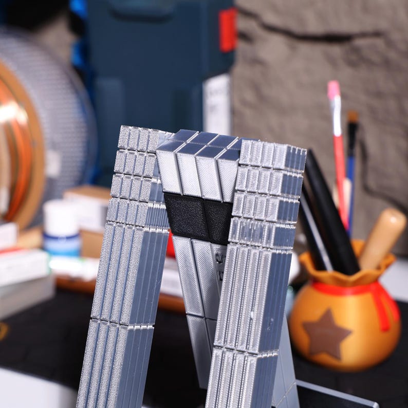 Interstellar robot figure collectible, TARS-inspired model with magnetic joints, sci-fi movie memorabilia; realistic metal-like finish, modular parts; popular for desk decor, modern minimalist aesthetic, suitable for home and office sci-fi display.