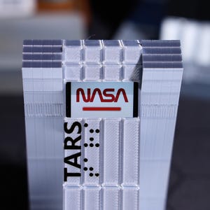 Unique Christmas gift for sci-fi lovers, TARS Robot desktop ornament with customizable display screen. Relive iconic movie scenes, perfect for home decor, personalized with holiday greetings, ideal for movie memorabilia collectors.