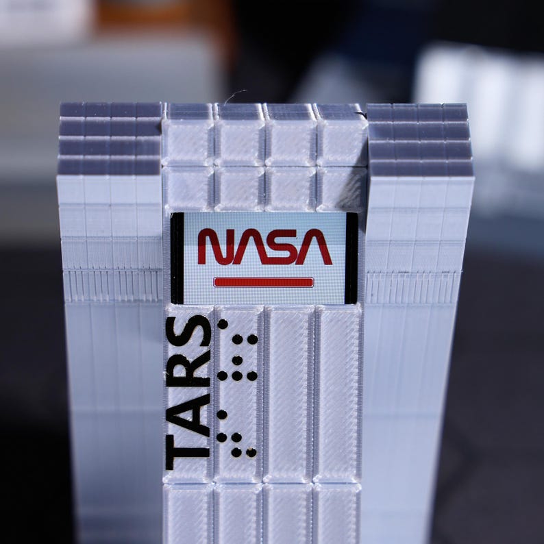 Unique Christmas gift for sci-fi lovers, TARS Robot desktop ornament with customizable display screen. Relive iconic movie scenes, perfect for home decor, personalized with holiday greetings, ideal for movie memorabilia collectors.