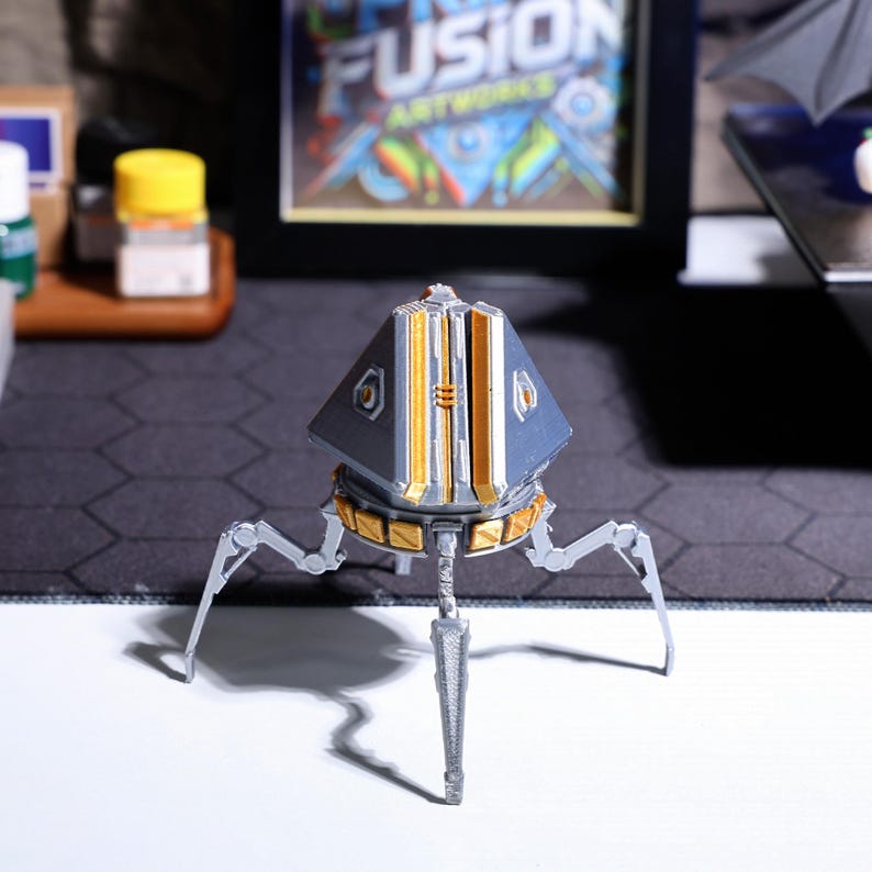 Custom-made gaming phone holder, unique Apex Legends loot box design, perfect for gamers, handcrafted from durable PLA material, a great option for gaming desk decor and hands-free phone viewing during gameplay or calls.