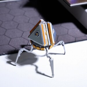 Rotatable loot box phone stand, ideal for gamers who need a multi-functional desk accessory, perfect for video calls and hands-free phone viewing, designed for Apex Legends fans, a perfect gift for gamers.