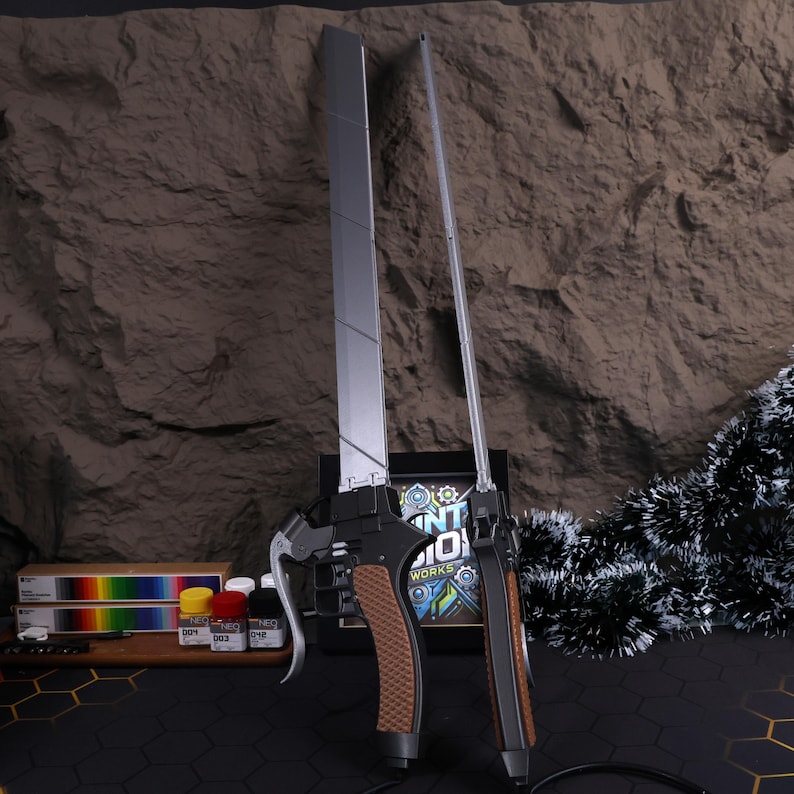 Attack on Titan cosplay dual blades, removable 20cm blades, 3D printed metal gloss finish with spring-loaded button mechanism. Great gift for anime lovers, collectors, and cosplay enthusiasts looking for high-quality replica sword props.