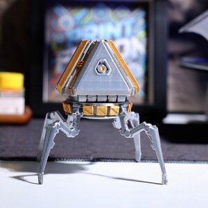 Eco-conscious phone stand with Apex Legends theme, features a rotatable head for easy viewing, great for multi-tasking during gameplay, a stylish addition to any gamer’s desk, and perfect for holding phones during video calls.