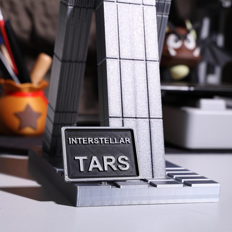 TARS robot figure collectible, sci-fi robot replica model, detailed modular joints; high-quality movie-inspired display figure for Interstellar fans, magnetic parts for adjustable posing, sleek metallic finishes for modern home decor or office shelf.