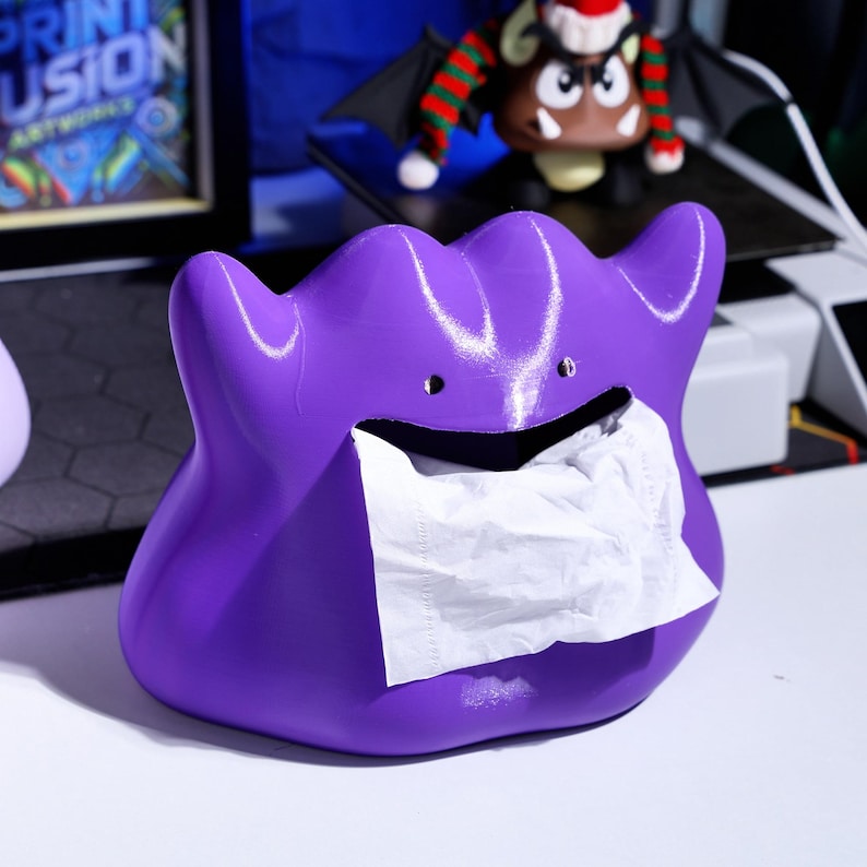 Unique monster-inspired tissue holder with soft texture and 3D print design. Featuring a magnetic base to keep it stable, this fun and quirky tissue box is perfect for gaming decor and creative office accessories.