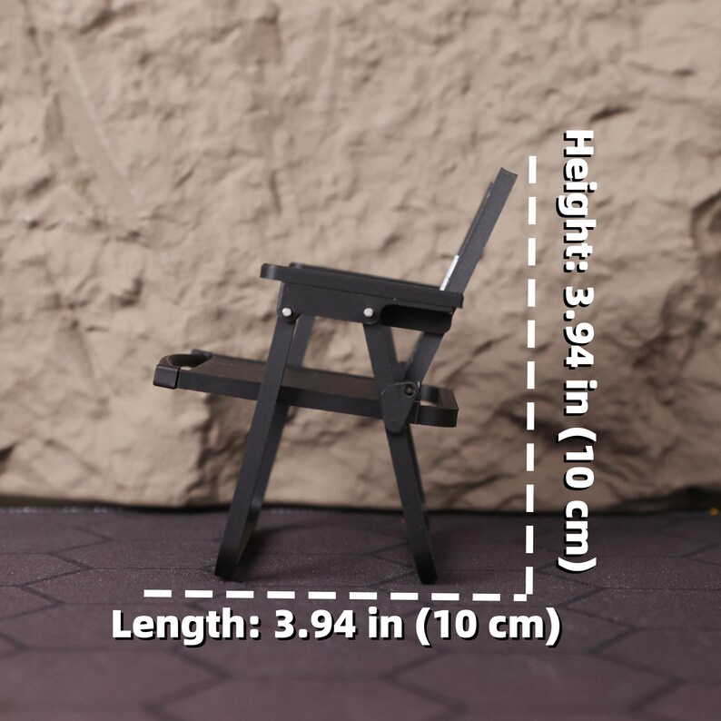 Angle shot of the miniature folding director’s chair, highlighting the printed logo on the fabric and the clean structure of the 3D print. This item is a great gift for aspiring directors, producers, and anyone studying or working in film. It serves as a daily reminder of your creative vision and love for cinema. Perfect for holiday gifting, birthdays, or special occasions for those passionate about storytelling and film production aesthetics.