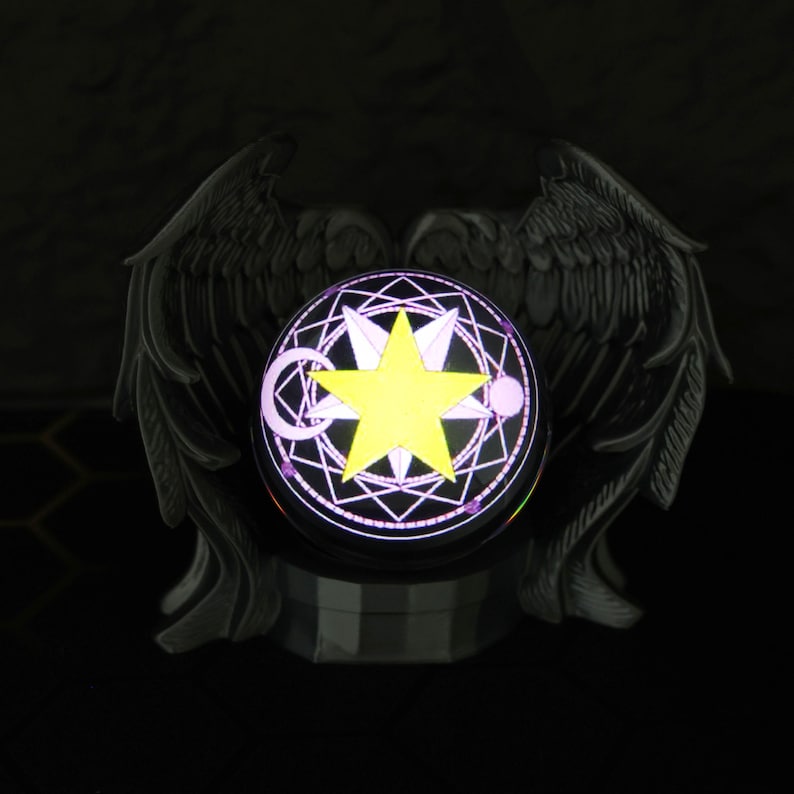 The magic orb LED display sits on a shelf surrounded by Fullmetal Alchemist and Naruto memorabilia, highlighting its customizable image projection and gamer-friendly size. With its USB-C charging feature and eerie yet stunning glow, this crystal ball is a must-have for anime collectors, fantasy fans, and those looking to give a unique holiday gift for him.