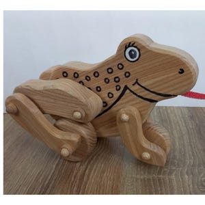 children&#39;s toy, moving frog on wheels, handmade, made of wood, covered with ecological varnish, moves in two directions: forward, backward